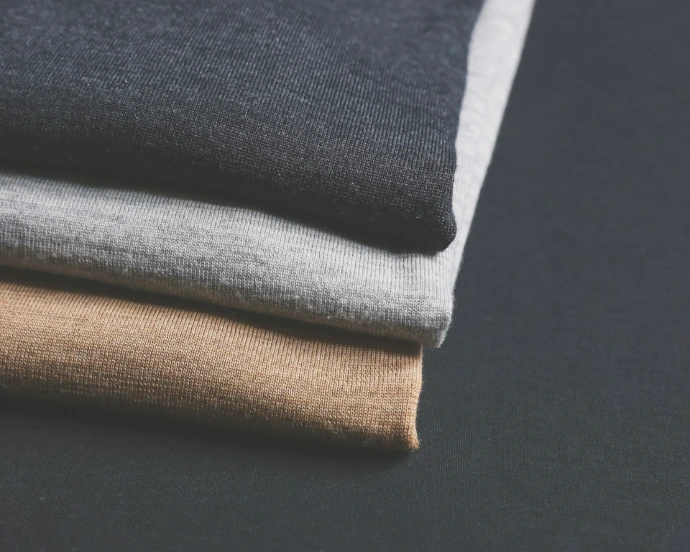 piled of black, gray, and brown clothes
